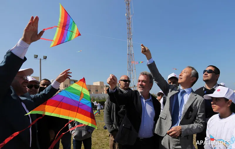 Bo Schack, director of United Nations Relief and Works Agency operations in Gaza, and Japanese ambassador Takeshi Okubo fly kites during an event organised by the United Nations Relief and Works Agency (UNRWA) to mark th...