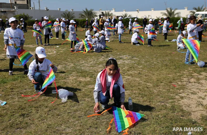 Palestinian schoolgirls fly kites to show solidarity with the Japanese people during an event organised by the United Nations Relief and Works Agency (UNRWA) to mark the the sixth anniversary of the Tohoku earthquake and...