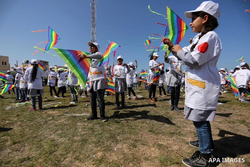 Palestinian schoolgirls fly kites to show solidarity with the Japanese people during an event organised by the United Nations Relief and Works Agency (UNRWA) to mark the the sixth anniversary of the Tohoku earthquake and...