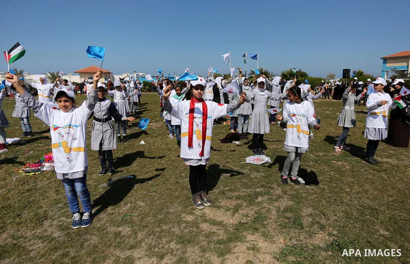 Palestinian schoolgirls fly kites to show solidarity with the Japanese people during an event organised by the United Nations Relief and Works Agency (UNRWA) to mark the the sixth anniversary of the Tohoku earthquake and...