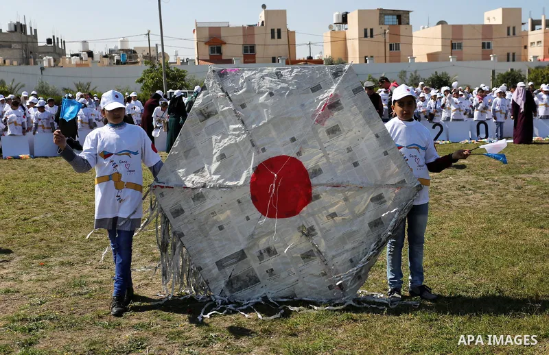 Palestinian schoolgirls fly kites to show solidarity with the Japanese people during an event organised by the United Nations Relief and Works Agency (UNRWA) to mark the the sixth anniversary of the Tohoku earthquake and...