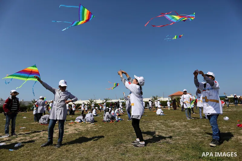 Palestinian schoolgirls fly kites to show solidarity with the Japanese people during an event organised by the United Nations Relief and Works Agency (UNRWA) to mark the the sixth anniversary of the Tohoku earthquake and...