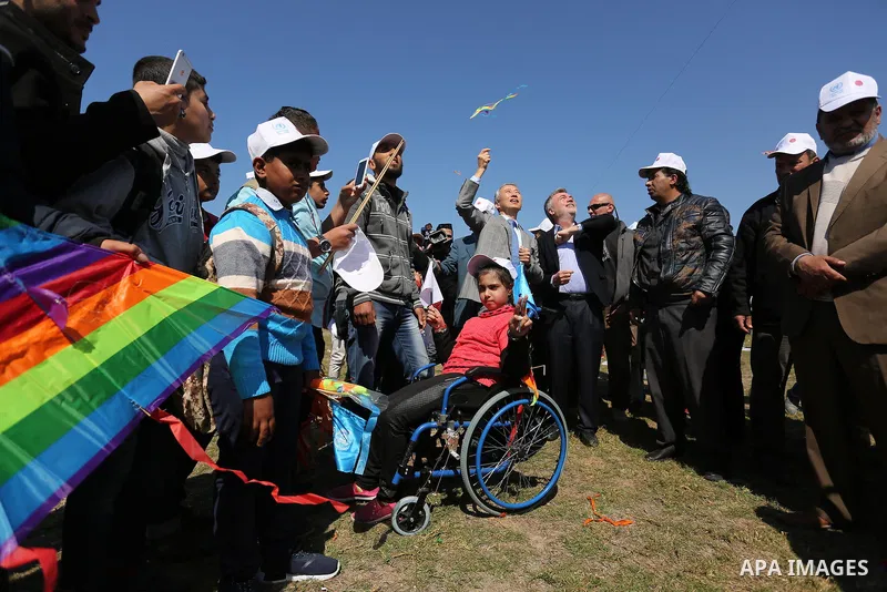 Bo Schack, director of United Nations Relief and Works Agency operations in Gaza, and Japanese ambassador Takeshi Okubo fly kites during an event organised by the United Nations Relief and Works Agency (UNRWA) to mark th...