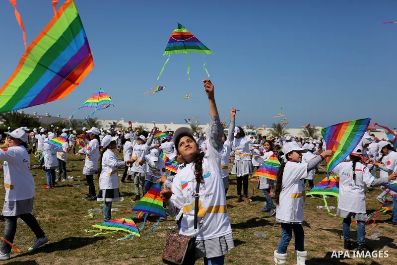 Palestinian schoolgirls fly kites to show solidarity with the Japanese people during an event organised by the United Nations Relief and Works Agency (UNRWA) to mark the the sixth anniversary of the Tohoku earthquake and...