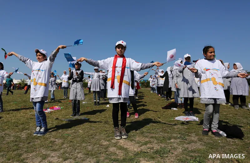 Palestinian schoolgirls fly kites to show solidarity with the Japanese people during an event organised by the United Nations Relief and Works Agency (UNRWA) to mark the the sixth anniversary of the Tohoku earthquake and...