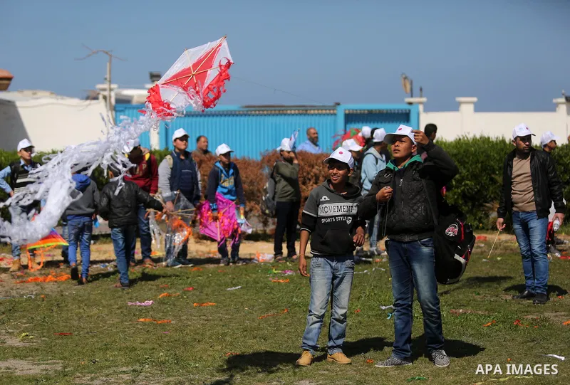 Palestinian schoolboys fly kites to show solidarity with the Japanese people during an event organised by the United Nations Relief and Works Agency (UNRWA) to mark the the sixth anniversary of the Tohoku earthquake and...