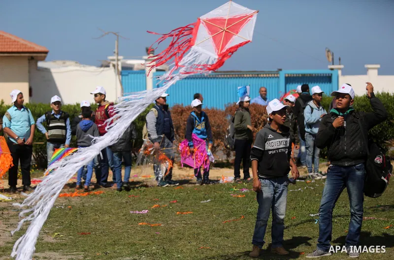 Palestinian schoolboys fly kites to show solidarity with the Japanese people during an event organised by the United Nations Relief and Works Agency (UNRWA) to mark the the sixth anniversary of the Tohoku earthquake and...