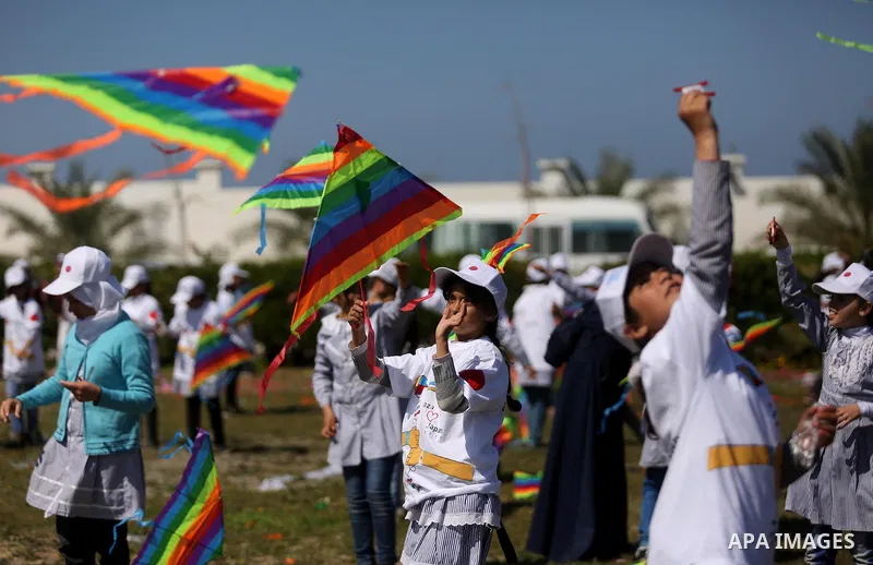 Palestinian schoolgirls fly kites to show solidarity with the Japanese people during an event organised by the United Nations Relief and Works Agency (UNRWA) to mark the the sixth anniversary of the Tohoku earthquake and...