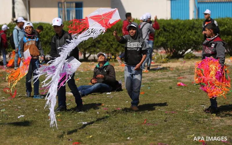 Palestinian schoolboys fly kites to show solidarity with the Japanese people during an event organised by the United Nations Relief and Works Agency (UNRWA) to mark the the sixth anniversary of the Tohoku earthquake and...