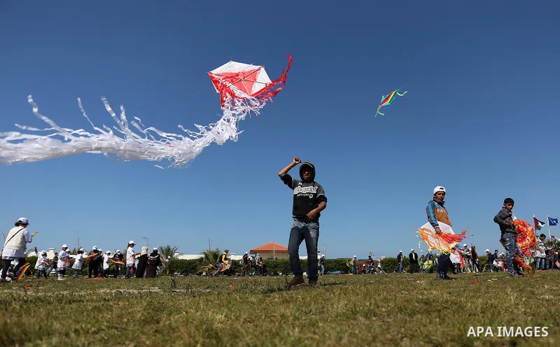 Palestinian schoolboys fly kites to show solidarity with the Japanese people during an event organised by the United Nations Relief and Works Agency (UNRWA) to mark the the sixth anniversary of the Tohoku earthquake and...