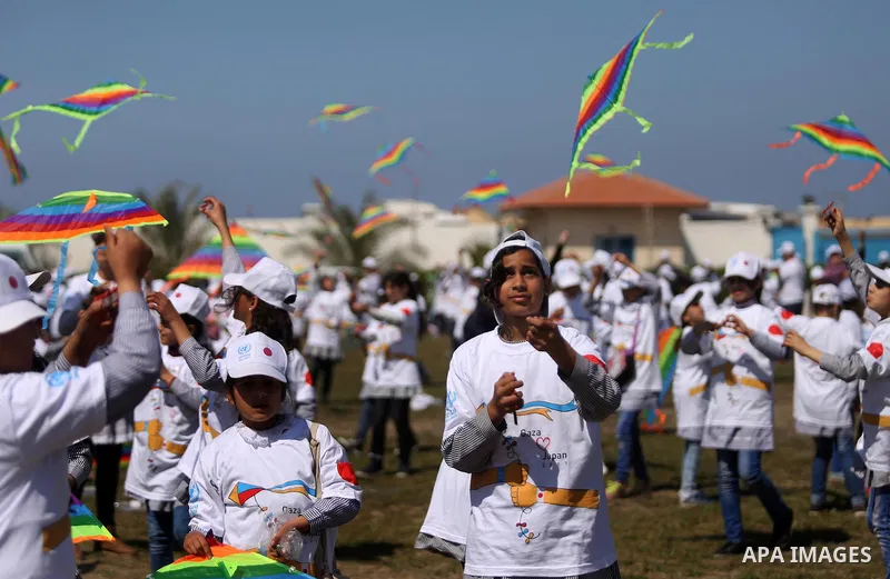 Palestinian schoolgirls fly kites to show solidarity with the Japanese people during an event organised by the United Nations Relief and Works Agency (UNRWA) to mark the the sixth anniversary of the Tohoku earthquake and...