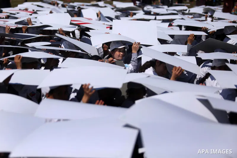 Palestinian schoolgirls fly kites to show solidarity with the Japanese people during an event organised by the United Nations Relief and Works Agency (UNRWA) to mark the the sixth anniversary of the Tohoku earthquake and...
