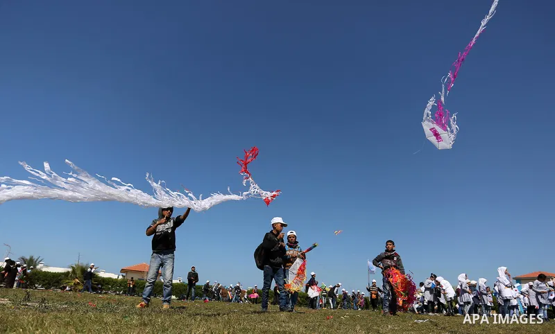 Palestinian schoolboys fly kites to show solidarity with the Japanese people during an event organised by the United Nations Relief and Works Agency (UNRWA) to mark the the sixth anniversary of the Tohoku earthquake and...