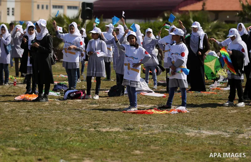 Palestinian schoolgirls fly kites to show solidarity with the Japanese people during an event organised by the United Nations Relief and Works Agency (UNRWA) to mark the the sixth anniversary of the Tohoku earthquake and...