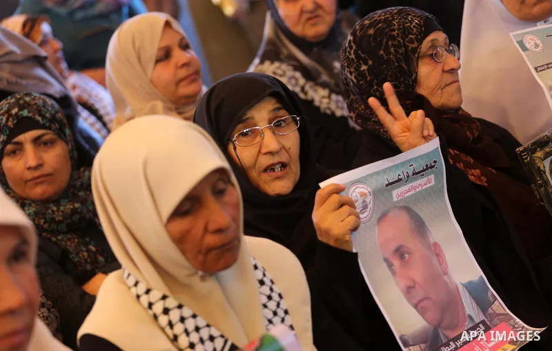 Palestinians hold placards during a protest to show solidarity with Palestinian prisoners held in Israeli Jails, in front of Red cross office in Gaza city, on March 6, 2017. Photo by Mohammed Asad