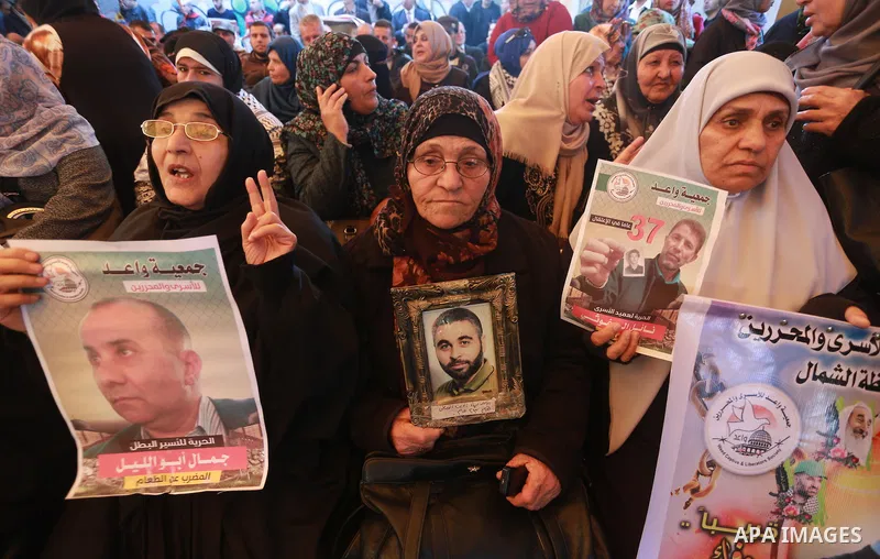 Palestinians hold placards during a protest to show solidarity with Palestinian prisoners held in Israeli Jails, in front of Red cross office in Gaza city, on March 6, 2017. Photo by Mohammed Asad