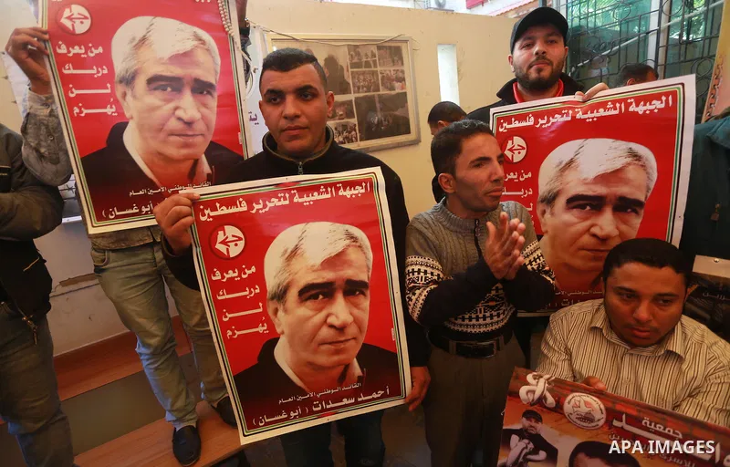 Palestinians hold placards during a protest to show solidarity with Palestinian prisoners held in Israeli Jails, in front of Red cross office in Gaza city, on March 6, 2017. Photo by Mohammed Asad