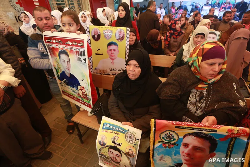 Palestinians hold placards during a protest to show solidarity with Palestinian prisoners held in Israeli Jails, in front of Red cross office in Gaza city, on March 6, 2017. Photo by Mohammed Asad