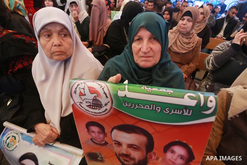 Palestinians hold placards during a protest to show solidarity with Palestinian prisoners held in Israeli Jails, in front of Red cross office in Gaza city, on March 6, 2017. Photo by Mohammed Asad
