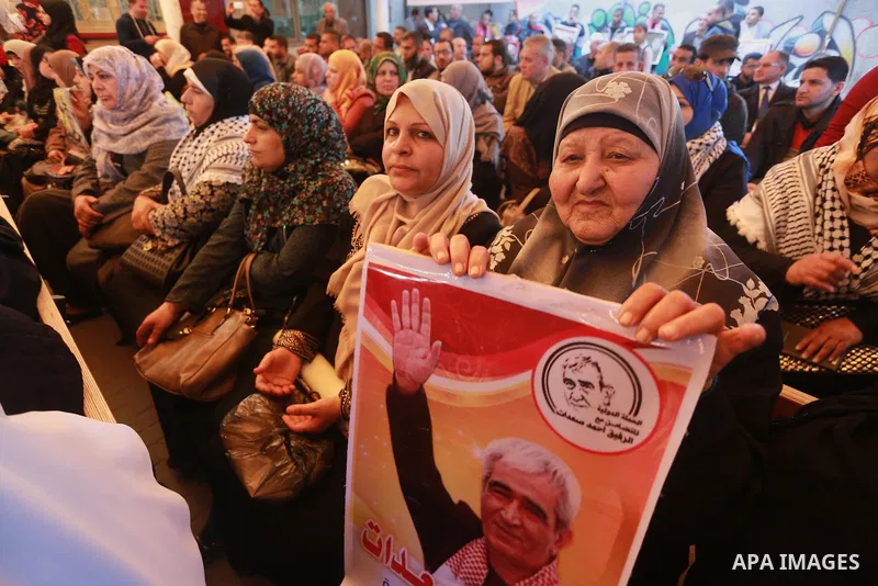 Palestinians hold placards during a protest to show solidarity with Palestinian prisoners held in Israeli Jails, in front of Red cross office in Gaza city, on March 6, 2017. Photo by Mohammed Asad