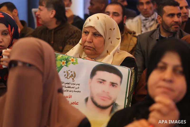 Palestinians hold placards during a protest to show solidarity with Palestinian prisoners held in Israeli Jails, in front of Red cross office in Gaza city, on March 6, 2017. Photo by Mohammed Asad