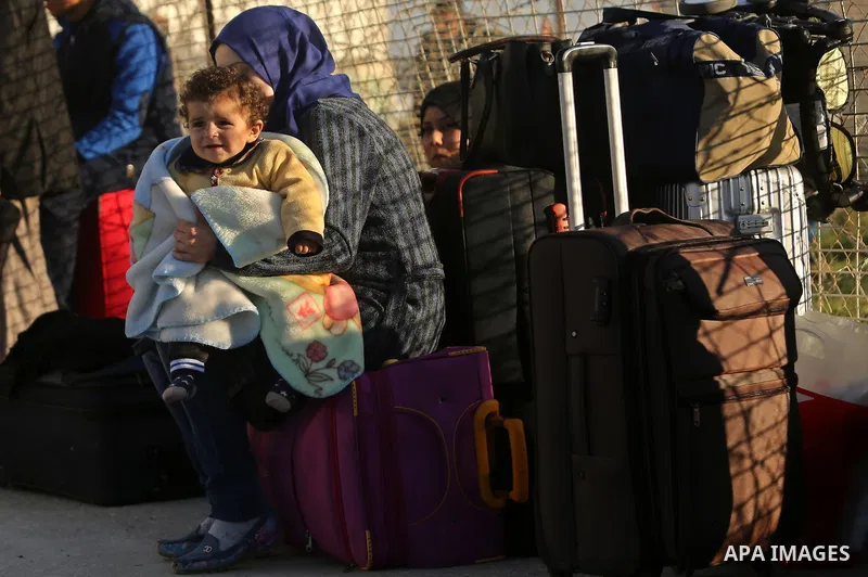 Palestinians wait for travel permits to cross into Egypt through the Rafah border crossing after it was opened by Egyptian authorities for humanitarian cases, in Rafah in the southern Gaza Strip on March 6, 2017. Photo b...