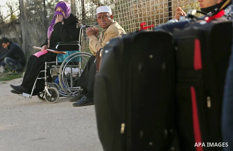 Palestinians wait for travel permits to cross into Egypt through the Rafah border crossing after it was opened by Egyptian authorities for humanitarian cases, in Rafah in the southern Gaza Strip on March 6, 2017. Photo b...