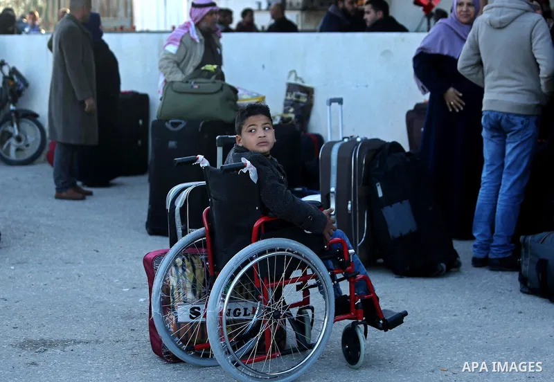 Palestinians wait for travel permits to cross into Egypt through the Rafah border crossing after it was opened by Egyptian authorities for humanitarian cases, in Rafah in the southern Gaza Strip on March 6, 2017. Photo b...