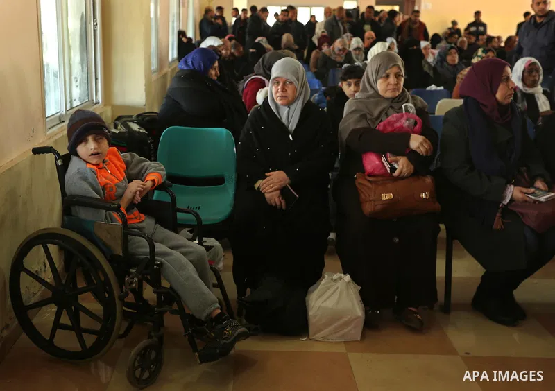 Palestinians wait for travel permits to cross into Egypt through the Rafah border crossing after it was opened by Egyptian authorities for humanitarian cases, in Rafah in the southern Gaza Strip on March 6, 2017. Photo b...