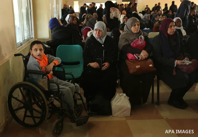 Palestinians wait for travel permits to cross into Egypt through the Rafah border crossing after it was opened by Egyptian authorities for humanitarian cases, in Rafah in the southern Gaza Strip on March 6, 2017. Photo b...