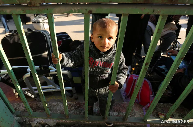 Palestinians wait for travel permits to cross into Egypt through the Rafah border crossing after it was opened by Egyptian authorities for humanitarian cases, in Rafah in the southern Gaza Strip on March 6, 2017. Photo b...