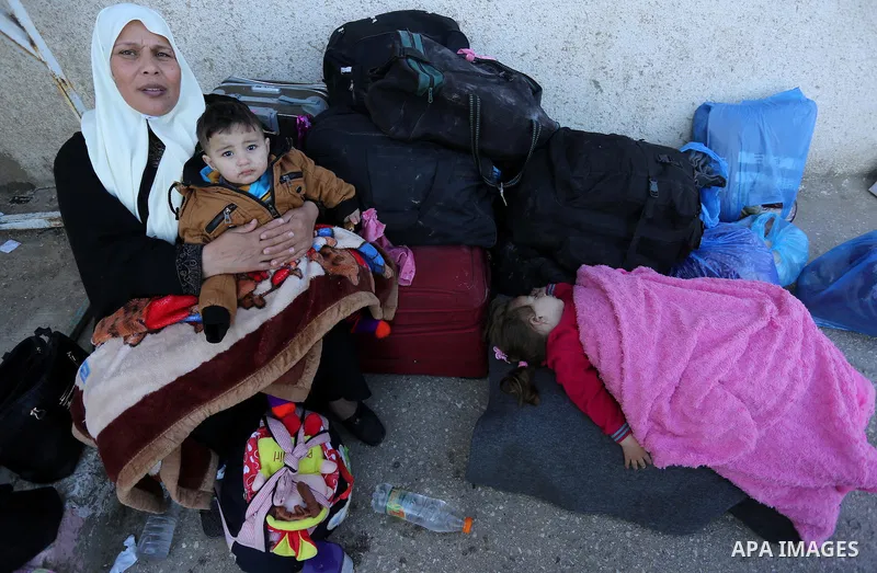 Palestinians wait for travel permits to cross into Egypt through the Rafah border crossing after it was opened by Egyptian authorities for humanitarian cases, in Rafah in the southern Gaza Strip on March 6, 2017. Photo b...