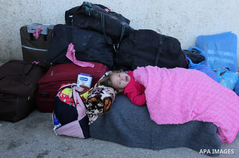 Palestinians wait for travel permits to cross into Egypt through the Rafah border crossing after it was opened by Egyptian authorities for humanitarian cases, in Rafah in the southern Gaza Strip on March 6, 2017. Photo b...