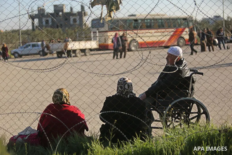 Palestinians wait for travel permits to cross into Egypt through the Rafah border crossing after it was opened by Egyptian authorities for humanitarian cases, in Rafah in the southern Gaza Strip on March 6, 2017. Photo b...