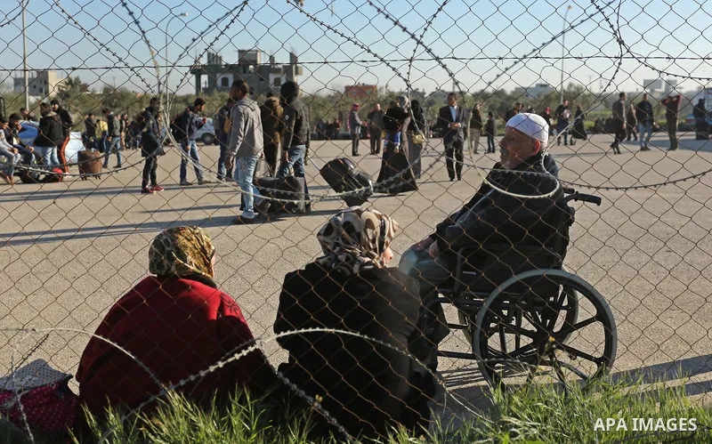 Palestinians wait for travel permits to cross into Egypt through the Rafah border crossing after it was opened by Egyptian authorities for humanitarian cases, in Rafah in the southern Gaza Strip on March 6, 2017. Photo b...