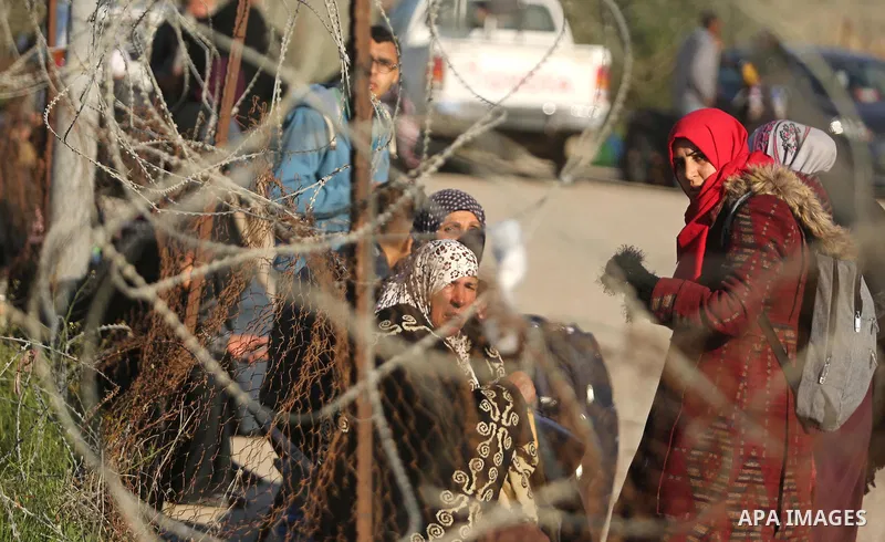 Palestinians wait for travel permits to cross into Egypt through the Rafah border crossing after it was opened by Egyptian authorities for humanitarian cases, in Rafah in the southern Gaza Strip on March 6, 2017. Photo b...