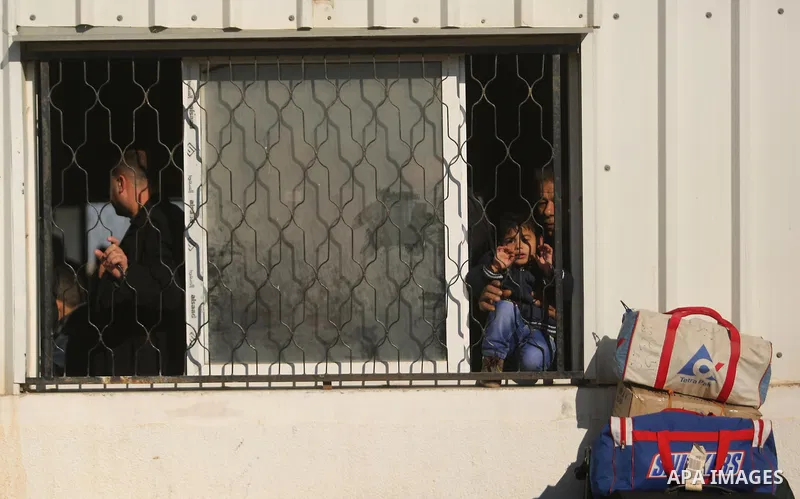 Palestinians wait for travel permits to cross into Egypt through the Rafah border crossing after it was opened by Egyptian authorities for humanitarian cases, in Rafah in the southern Gaza Strip on March 6, 2017. Photo b...