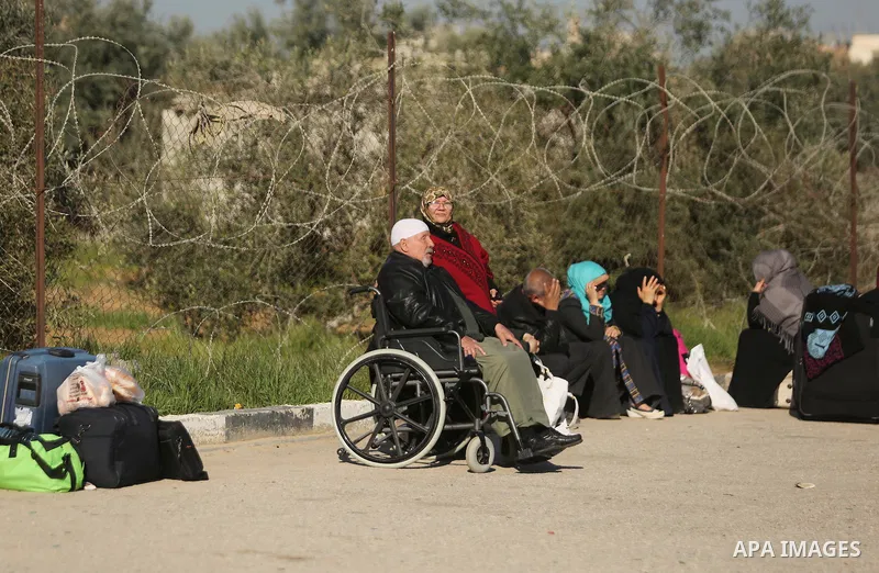 Palestinians wait for travel permits to cross into Egypt through the Rafah border crossing after it was opened by Egyptian authorities for humanitarian cases, in Rafah in the southern Gaza Strip on March 6, 2017. Photo b...