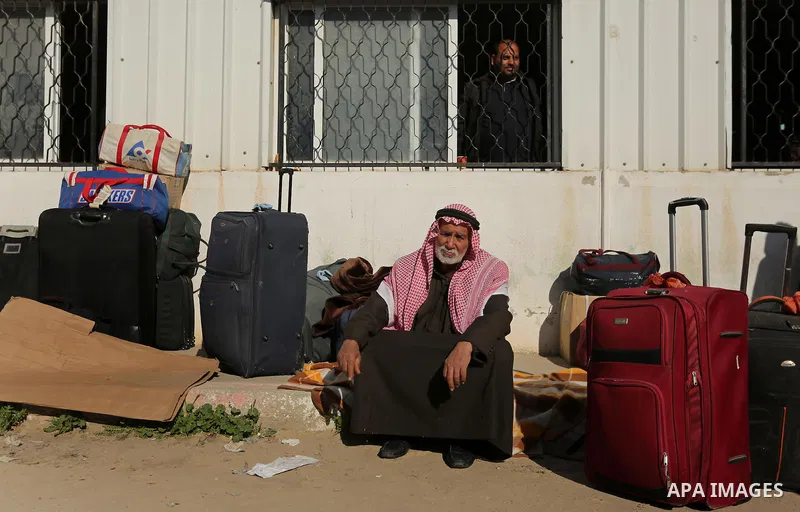 Palestinians wait for travel permits to cross into Egypt through the Rafah border crossing after it was opened by Egyptian authorities for humanitarian cases, in Rafah in the southern Gaza Strip on March 6, 2017. Photo b...