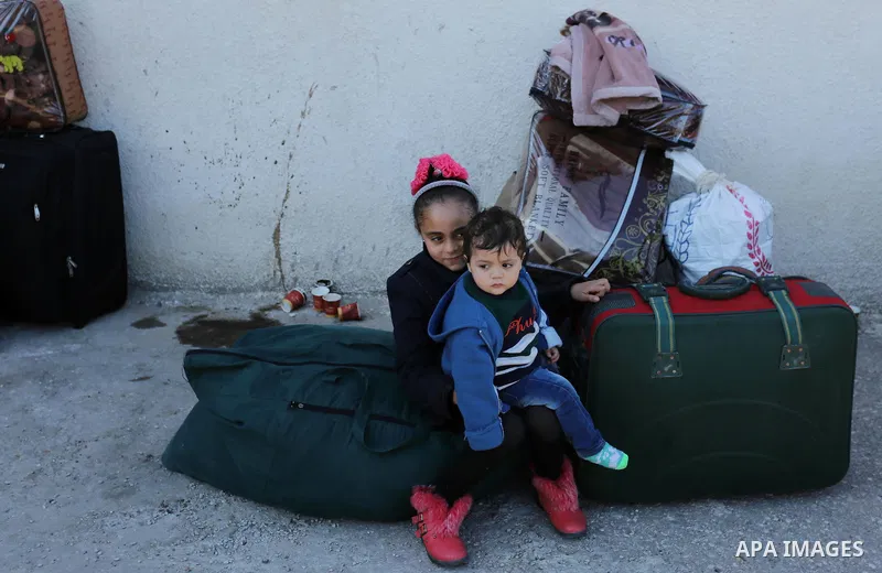 Palestinians wait for travel permits to cross into Egypt through the Rafah border crossing after it was opened by Egyptian authorities for humanitarian cases, in Rafah in the southern Gaza Strip on March 6, 2017. Photo b...