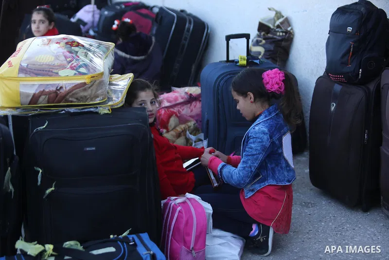 Palestinians wait for travel permits to cross into Egypt through the Rafah border crossing after it was opened by Egyptian authorities for humanitarian cases, in Rafah in the southern Gaza Strip on March 6, 2017. Photo b...