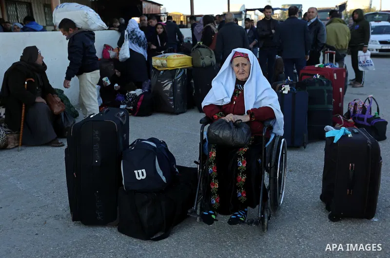 Palestinians wait for travel permits to cross into Egypt through the Rafah border crossing after it was opened by Egyptian authorities for humanitarian cases, in Rafah in the southern Gaza Strip on March 6, 2017. Photo b...
