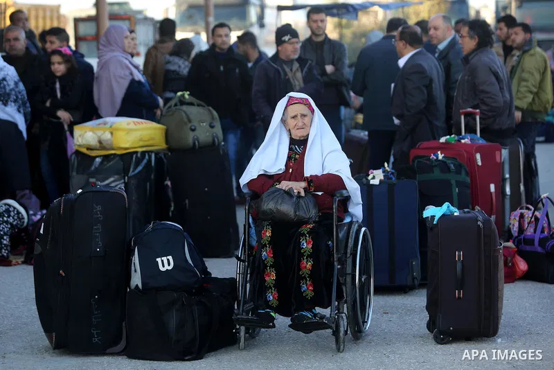 Palestinians wait for travel permits to cross into Egypt through the Rafah border crossing after it was opened by Egyptian authorities for humanitarian cases, in Rafah in the southern Gaza Strip on March 6, 2017. Photo b...