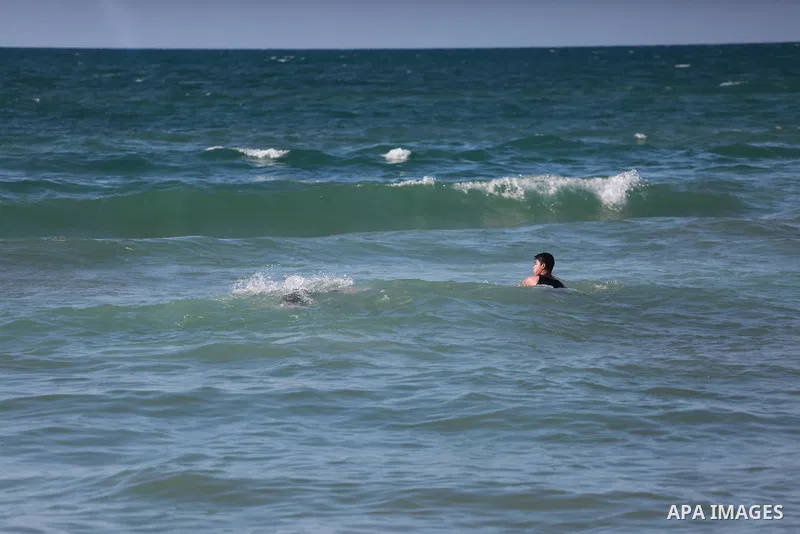 Palestinians swim as they enjoy in the Mediterranean Sea off the coast of Gaza City on March 6, 2017. Photo by Mohammed Asad