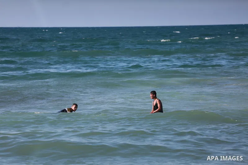 Palestinians swim as they enjoy in the Mediterranean Sea off the coast of Gaza City on March 6, 2017. Photo by Mohammed Asad