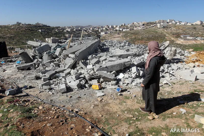 A Palestinian woman looks for her belongings amongst the rubble of her house after it was demolished by the Israeli army as it did not have an Israeli-issued construction permit, in the West Bank city of Hebron March 6,...
