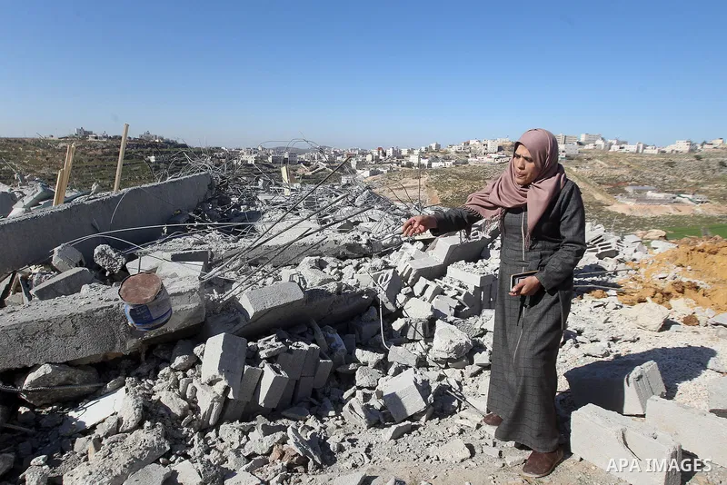 A Palestinian woman looks for her belongings amongst the rubble of her house after it was demolished by the Israeli army as it did not have an Israeli-issued construction permit, in the West Bank city of Hebron March 6,...
