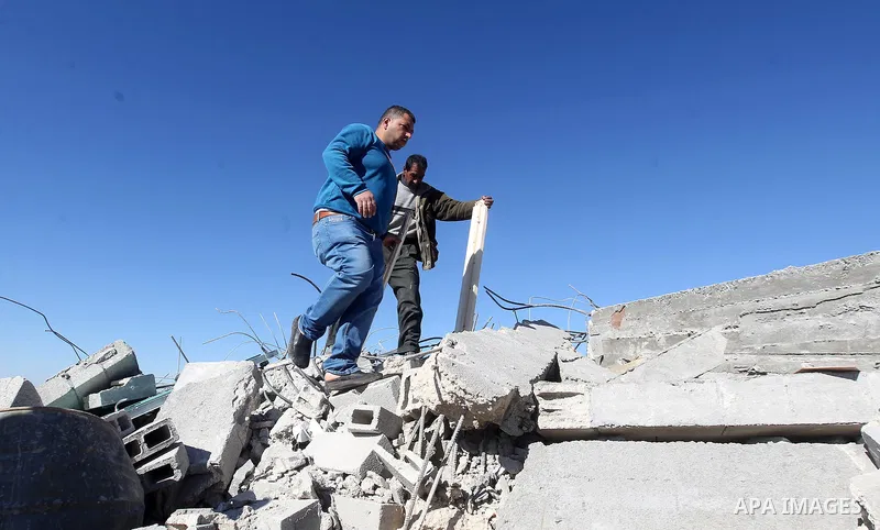 Palestinians remove belongings from rubble of a house after it was demolished by the Israeli army as it did not have an Israeli-issued construction permit, in the West Bank city of Hebron March 6, 2017. Photo by Wisam Ha...