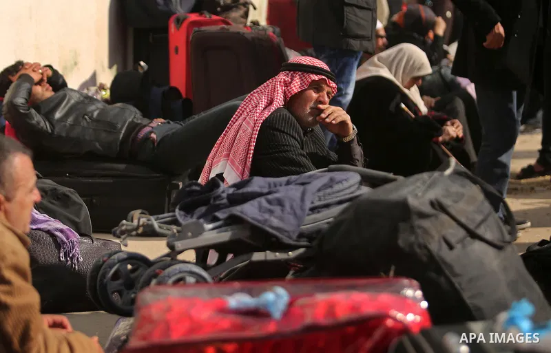 Palestinians wait for travel permits to cross into Egypt through the Rafah border crossing after it was opened by Egyptian authorities for humanitarian cases, in Rafah in the southern Gaza Strip on March 7, 2017. Photo b...