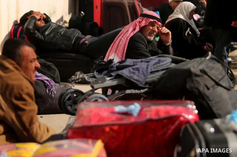 Palestinians wait for travel permits to cross into Egypt through the Rafah border crossing after it was opened by Egyptian authorities for humanitarian cases, in Rafah in the southern Gaza Strip on March 7, 2017. Photo b...